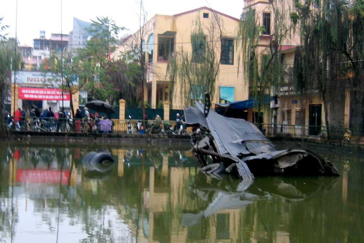 Submerged B-52 Plane Wreckage in Huu Tiep Lake Submerged remains of a B-52 plane in Huu Tiep Lake Hanoi surrounded by urban buildings and trees