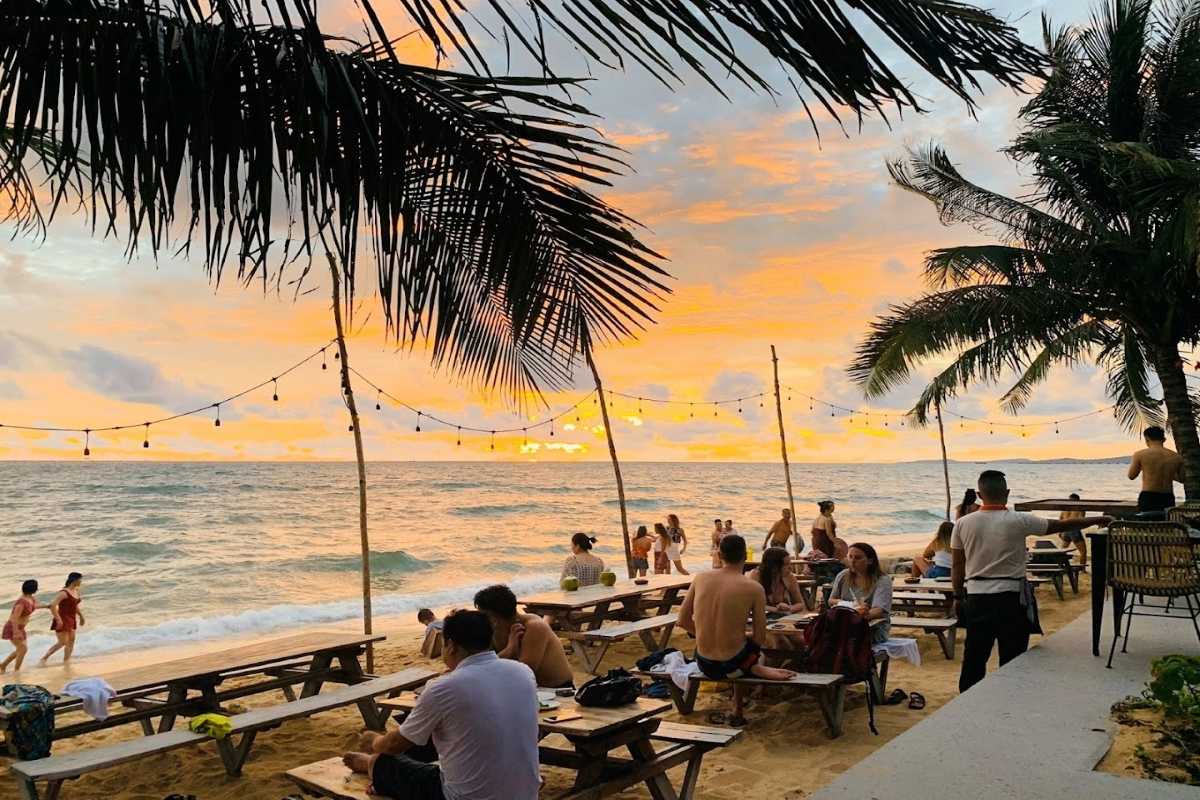 Sunset dining scene at Sunset Beach Bar & Restaurant Phu Quoc Island with guests enjoying ocean views