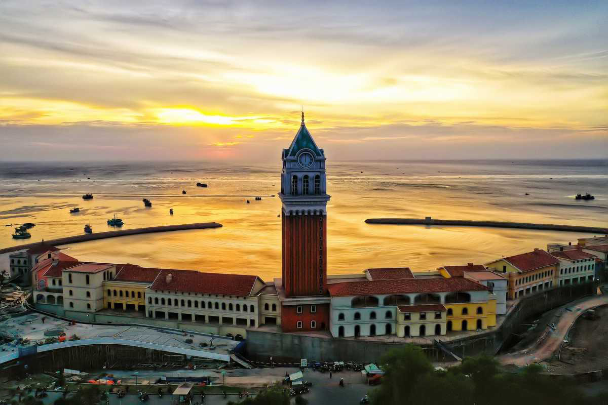 Clock Tower Phu Quoc with Vibrant Sunset Glow Sunset glow illuminating Clock Tower Phu Quoc against a colorful sky