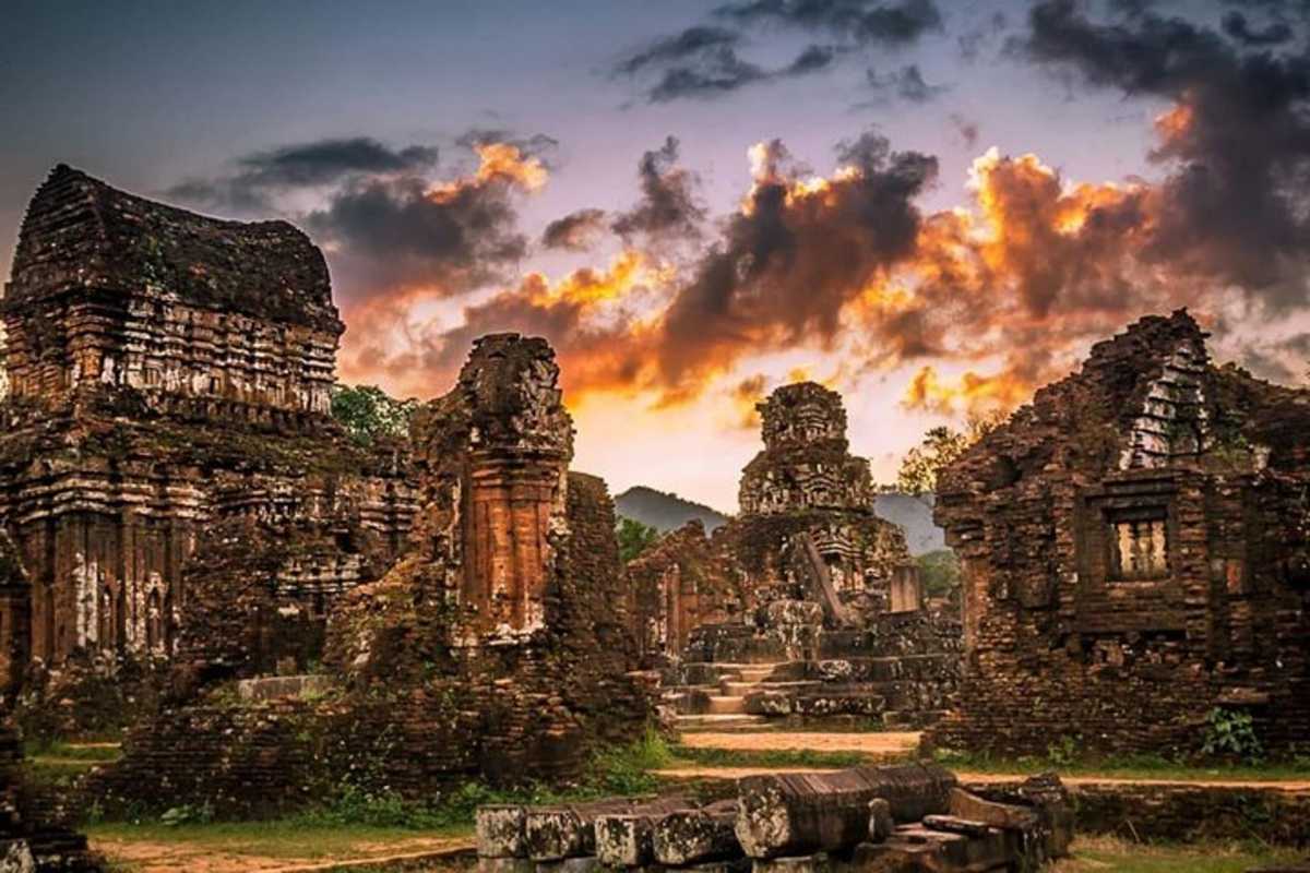 Sunset over My Son Sanctuary Ruins Sunset sky illuminating the ruins of My Son Sanctuary temples, creating a dramatic and serene atmosphere in the Vietnam heritage site