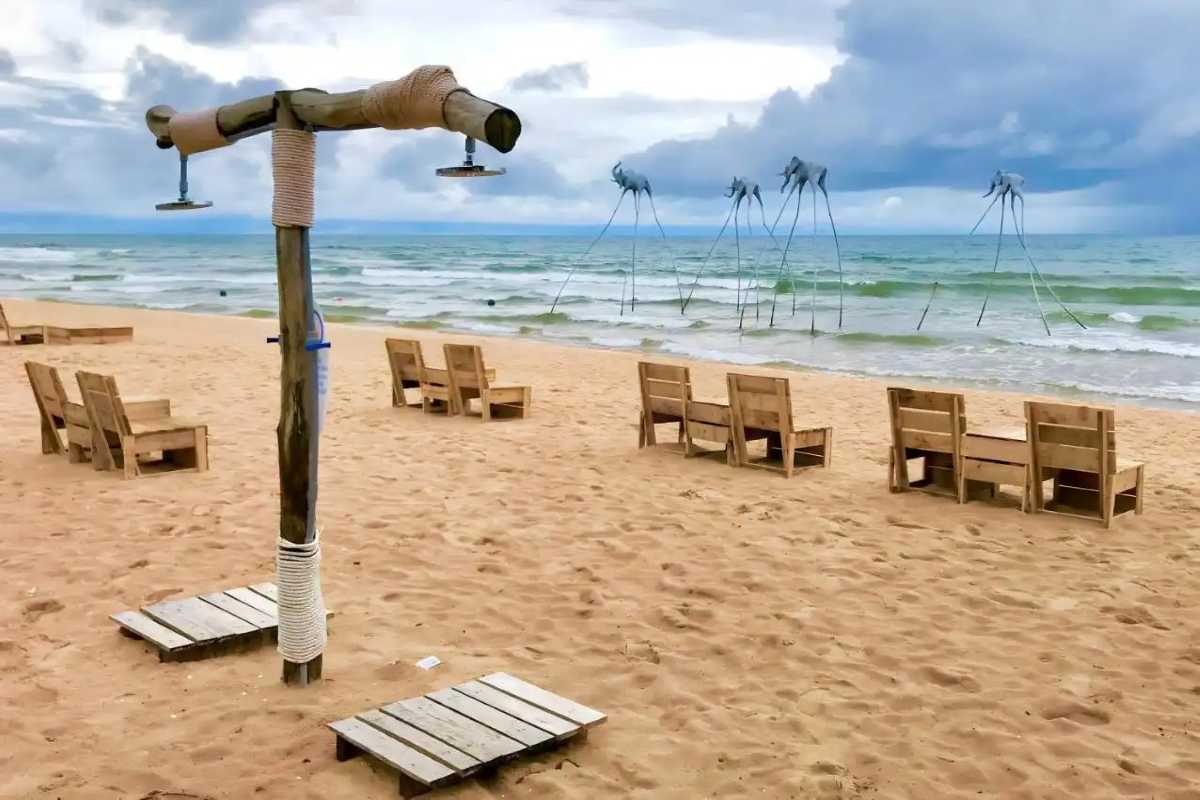 Sunset Sanato Phu Quoc Island Beach Seating and Art Wooden beach chairs facing sea and artistic installations at Sunset Sanato Phu Quoc Island