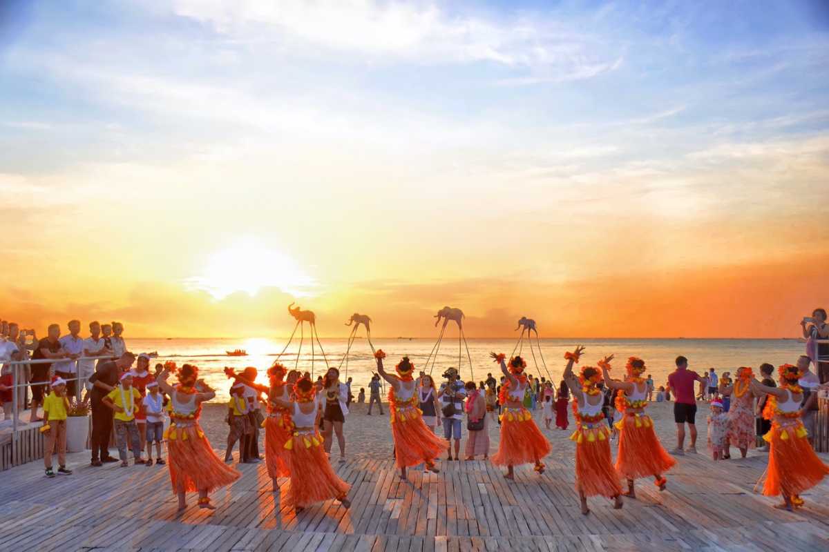 Sunset Sanato Phu Quoc Island Sunset Art Wire sculptures lit by the setting sun over the ocean at Sunset Sanato Phu Quoc Island