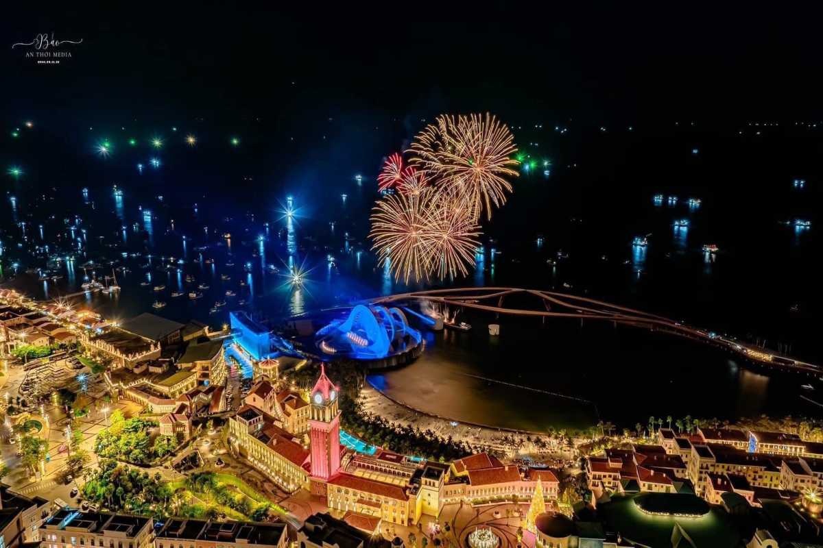 Sunset Town Phu Quoc Night Fireworks Celebration Nighttime fireworks over Sunset Town Phu Quoc with illuminated buildings and harbor
