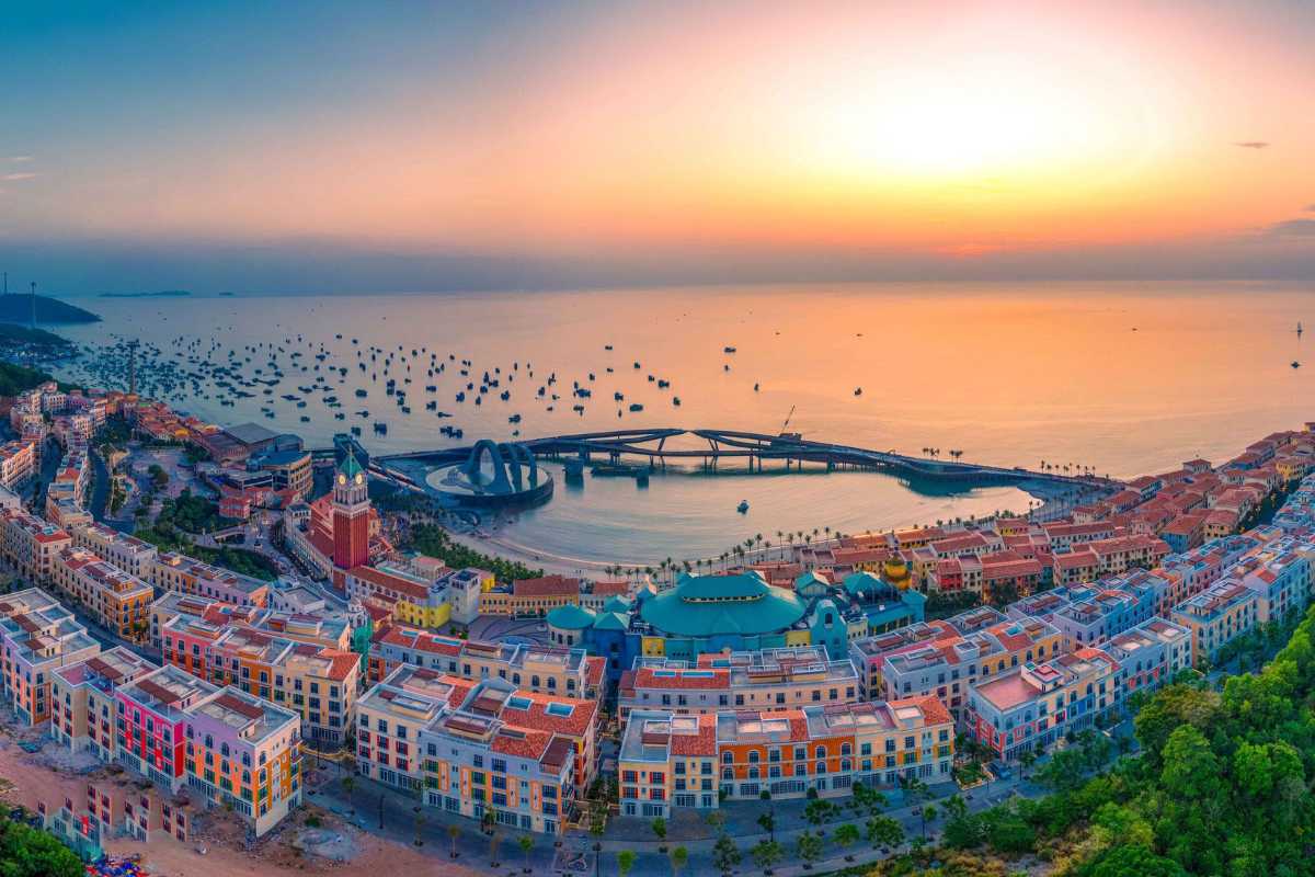 Panoramic coastal view of Sunset Town Phu Quoc at sunset with colorful buildings and calm sea