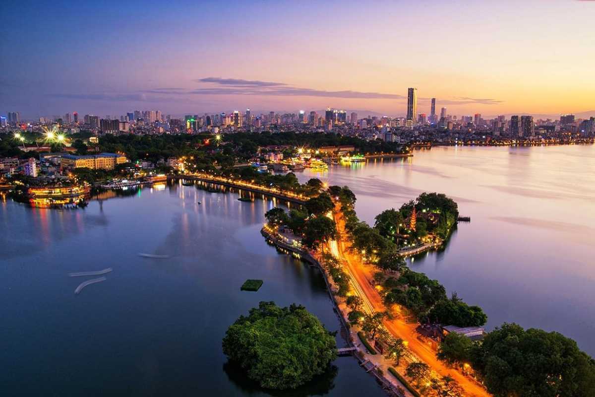 Sunset Over West Lake Hanoi and Hanoi Skyline Vibrant sunset sky over West Lake Hanoi with Hanoi skyline in the background