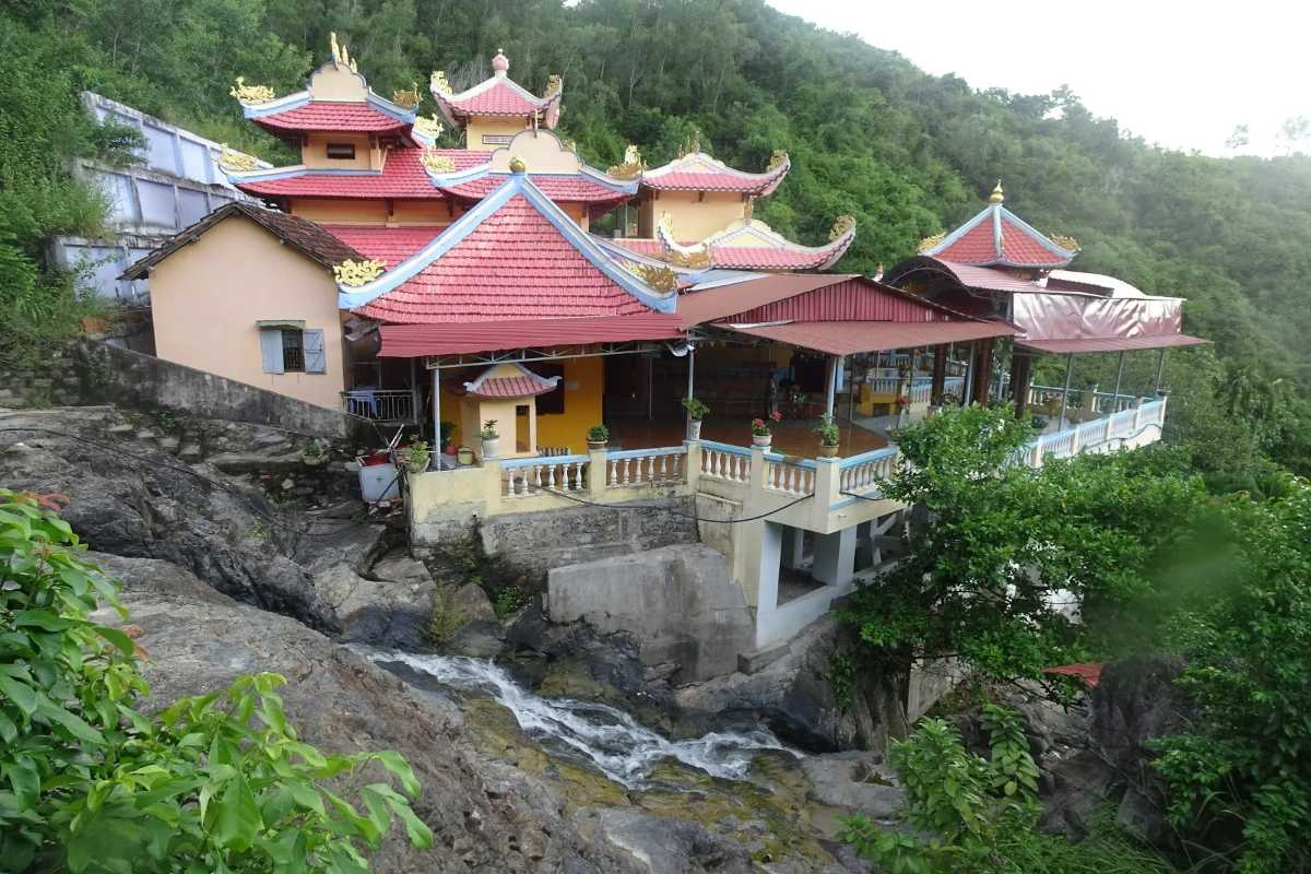 Suoi Do Pagoda temple complex with scenic forest backdrop The Suoi Do Pagoda temple buildings set against a lush green mountainous forest in Nha Trang