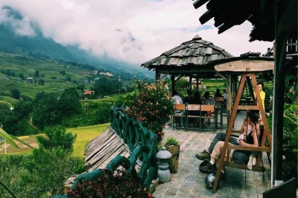 Ta Phin Village Sapa cafe with panoramic rice terrace views Ta Phin Village Sapa highlights a rustic outdoor cafe overlooking sweeping rice terraces and misty mountains
