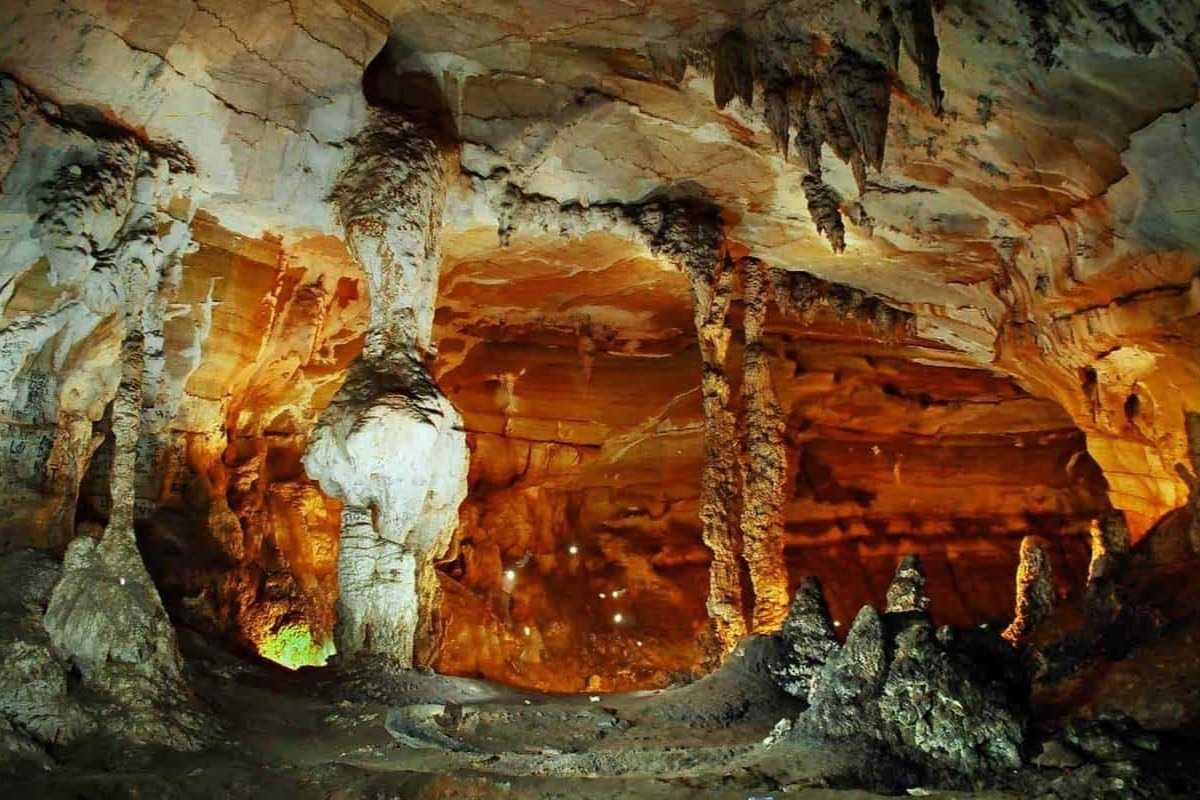 Ta Phin Village Sapa illuminated cave interior Cave interior in Ta Phin Village Sapa lit with golden lights, rock columns visible