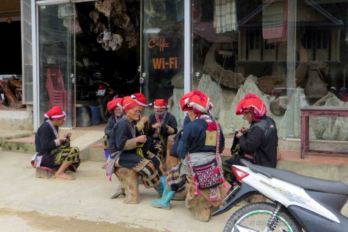 Ta Phin Village Sapa Red Dao artisans at café Red Dao women of Ta Phin Village Sapa crafting textiles outside local café