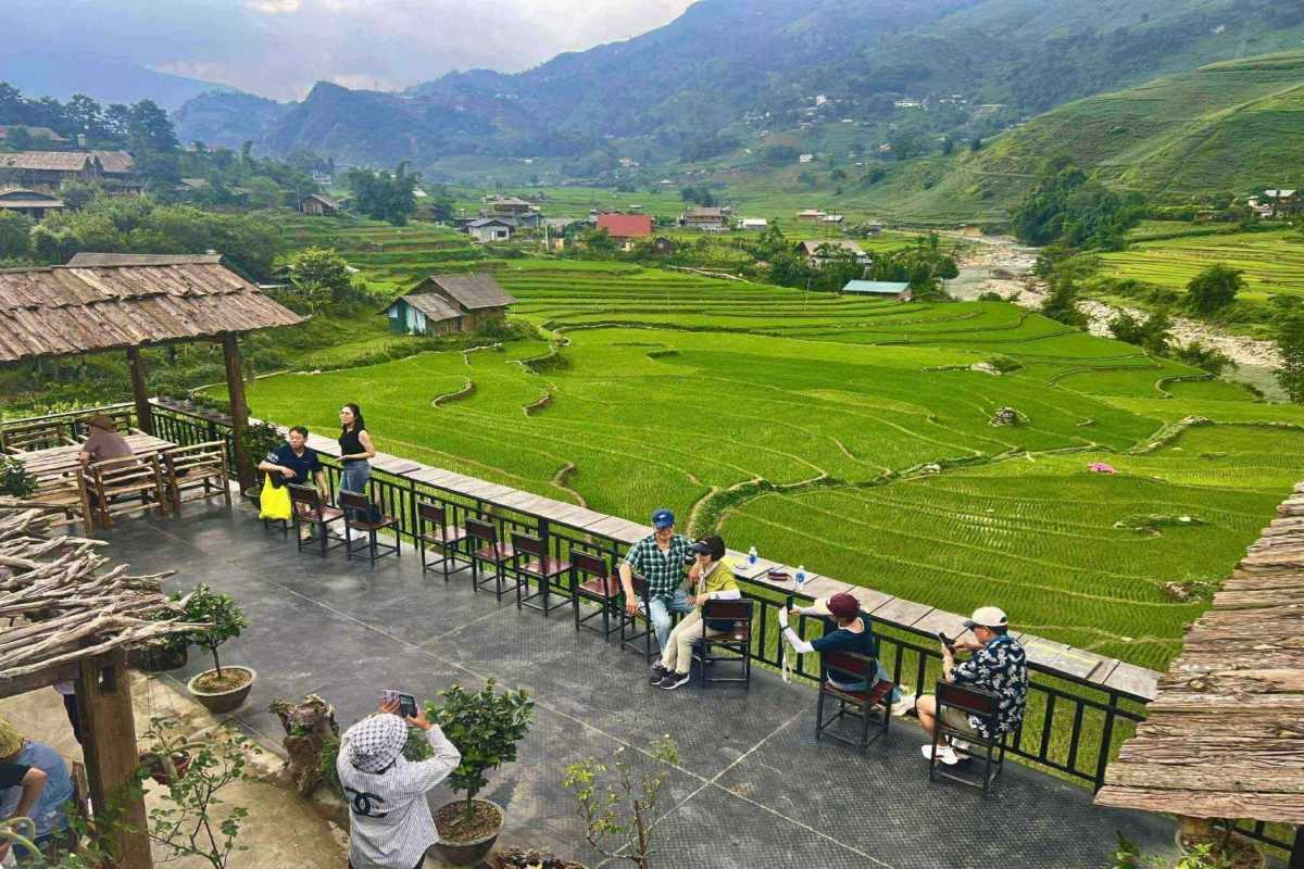 Ta Van Village Sapa lush green rice terraces view Ta Van Village Sapa displaying lush green rice terraces with traditional houses nestled among the hills and vibrant fields