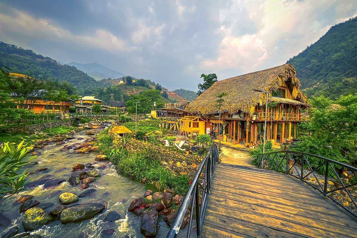 Ta Van Village Sapa Village Cluster Amidst Terraces Cluster of traditional wooden houses in Ta Van Village Sapa surrounded by green and golden rice terraces