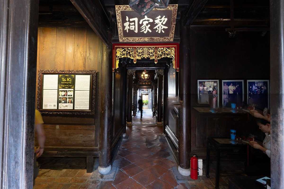 Dimly Lit Historic Hallway of Tan Ky Ancient House Dimly lit historic hallway inside Tan Ky Ancient House emphasizing traditional woodwork