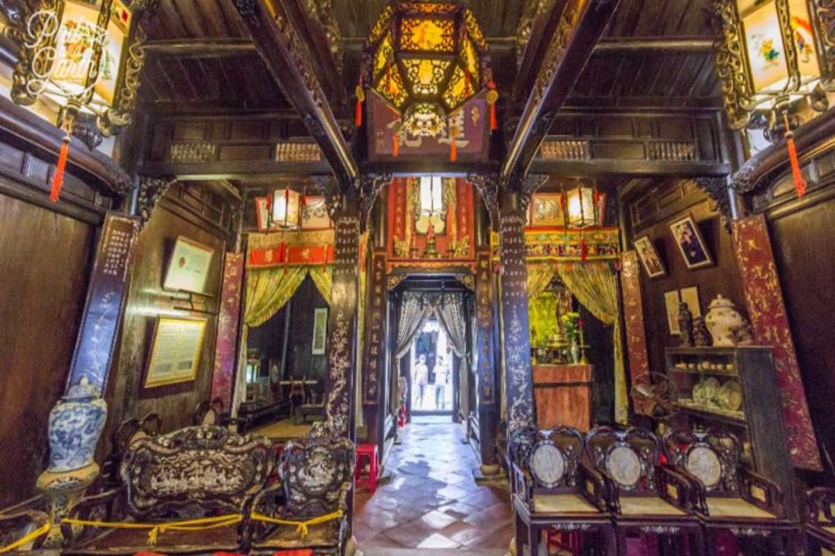 Historic Wooden Hallway in Tan Ky Ancient House Historic wooden hallway inside Tan Ky Ancient House showing carvings and lanterns