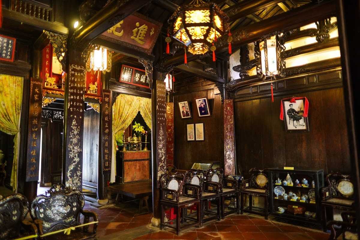 Lanterns Illuminating Tan Ky Ancient House Interior Lanterns illuminating the wooden interior of Tan Ky Ancient House, creating a warm ambiance
