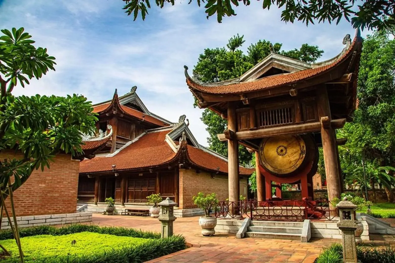 Drum tower and traditional Vietnamese architecture at the Temple of Literature in Hanoi, Vietnam, with wooden structures and red-tiled roofs.