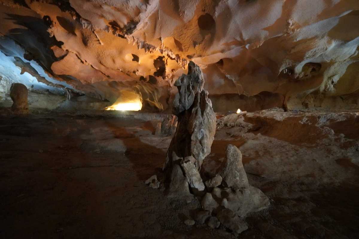 Interior Chamber of Thien Canh Son Cave Interior chamber of Thien Canh Son Cave featuring unique rock formations and dim lighting