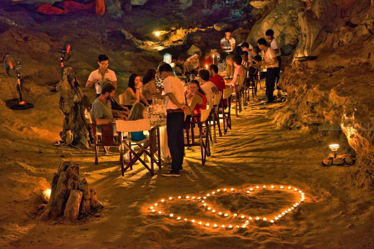 Lit Pathway Inside Thien Canh Son Cave Illuminated pathway winding through Thien Canh Son Cave, leading visitors safely through the cave