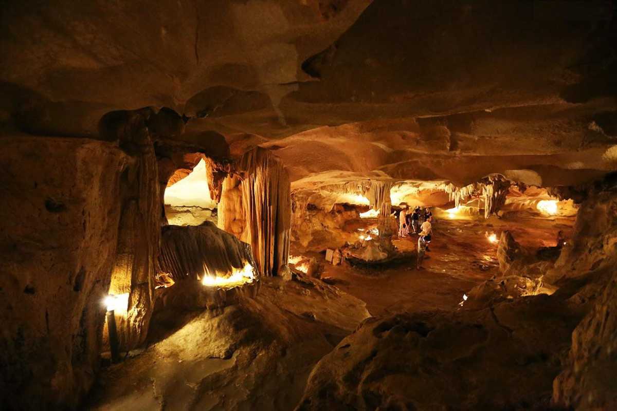 Spacious Interior of Thien Canh Son Cave Spacious interior of Thien Canh Son Cave with visitors exploring the vast natural chambers