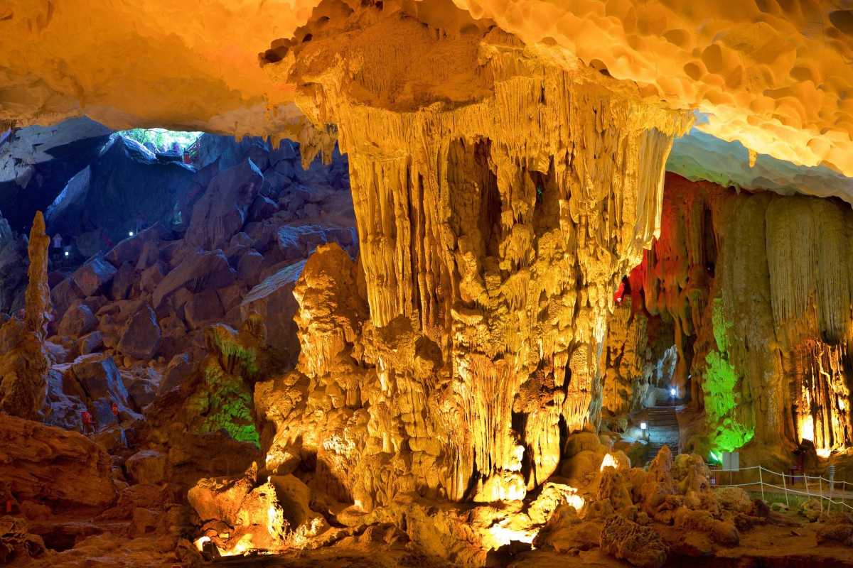 Tour Group Walking Inside Thien Canh Son Cave Group of tourists walking through illuminated areas inside Thien Canh Son Cave