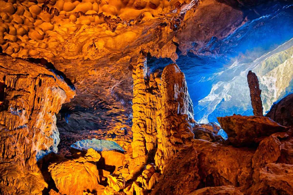 Tourists Exploring Thien Canh Son Cave Visitors walking inside Thien Canh Son Cave, surrounded by vast rock formations