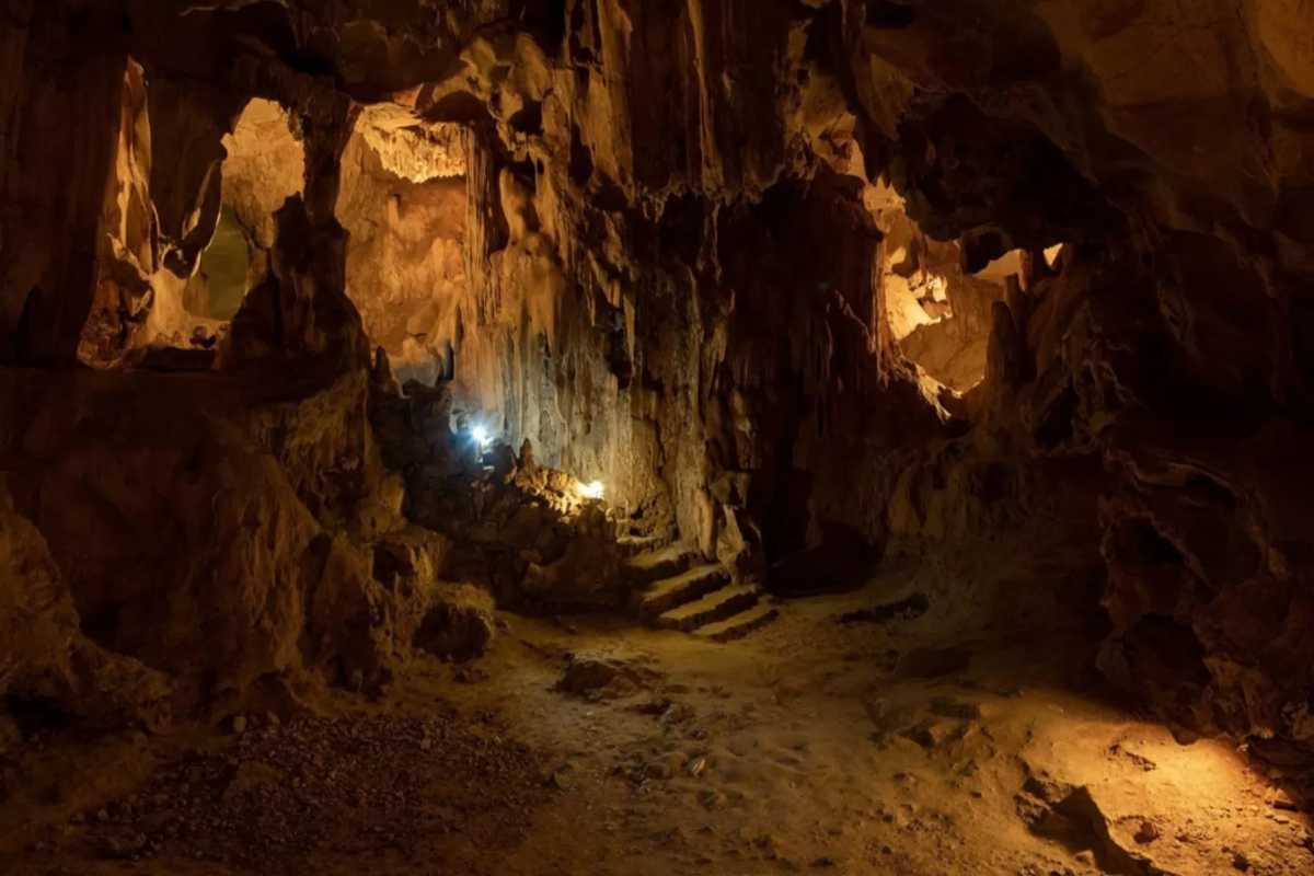 Thien Cung Cave Halong Bay dramatic lighting and rock formations Dramatic lighting highlights rock formations and textures inside Thien Cung Cave Halong Bay