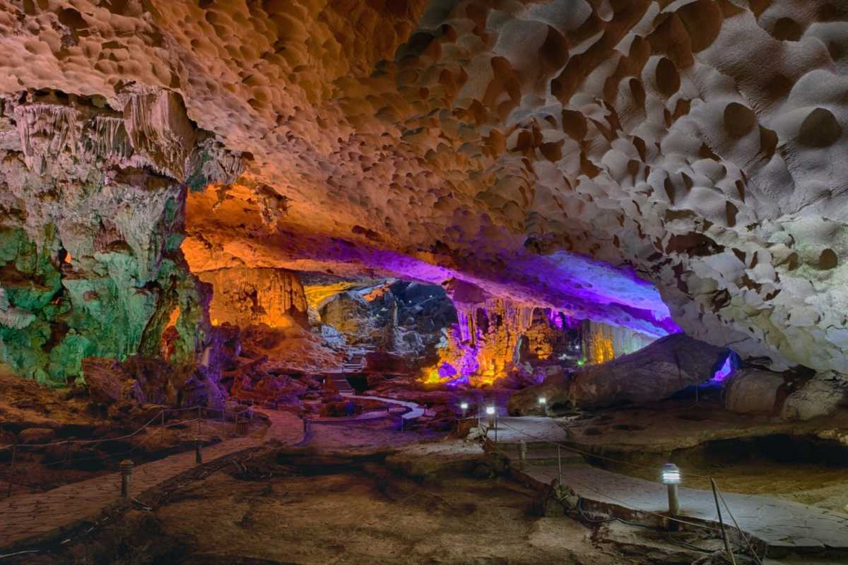 Thien Cung Cave Halong Bay dramatic cave lighting Thien Cung Cave Halong Bay features dramatic lighting accentuating unique rock formations and cavern textures
