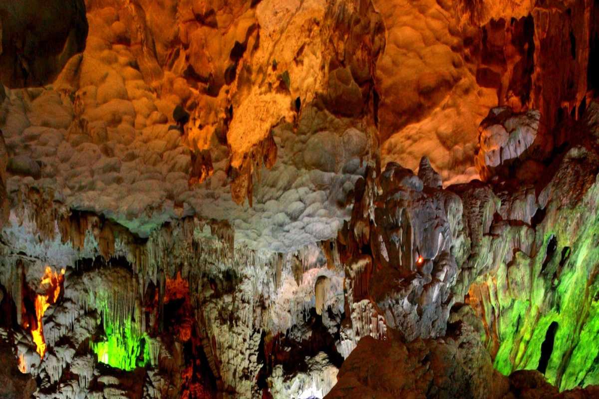 Thien Cung Cave Halong Bay illuminated cave interiors Thien Cung Cave Halong Bay features illuminated interiors showcasing intricate limestone formations and pathways