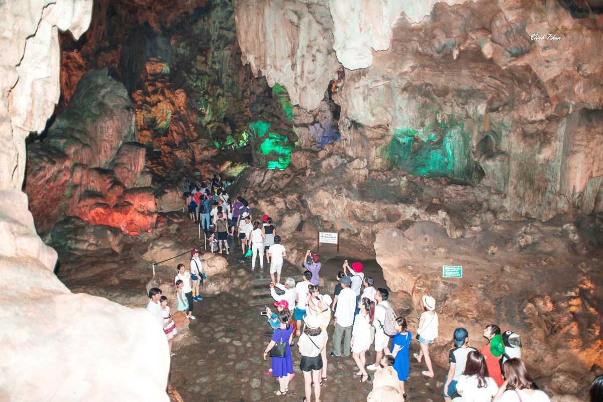 Thien Cung Cave Halong Bay tourists walking on trails Thien Cung Cave Halong Bay provides accessible trails allowing tourists to explore safely and comfortably