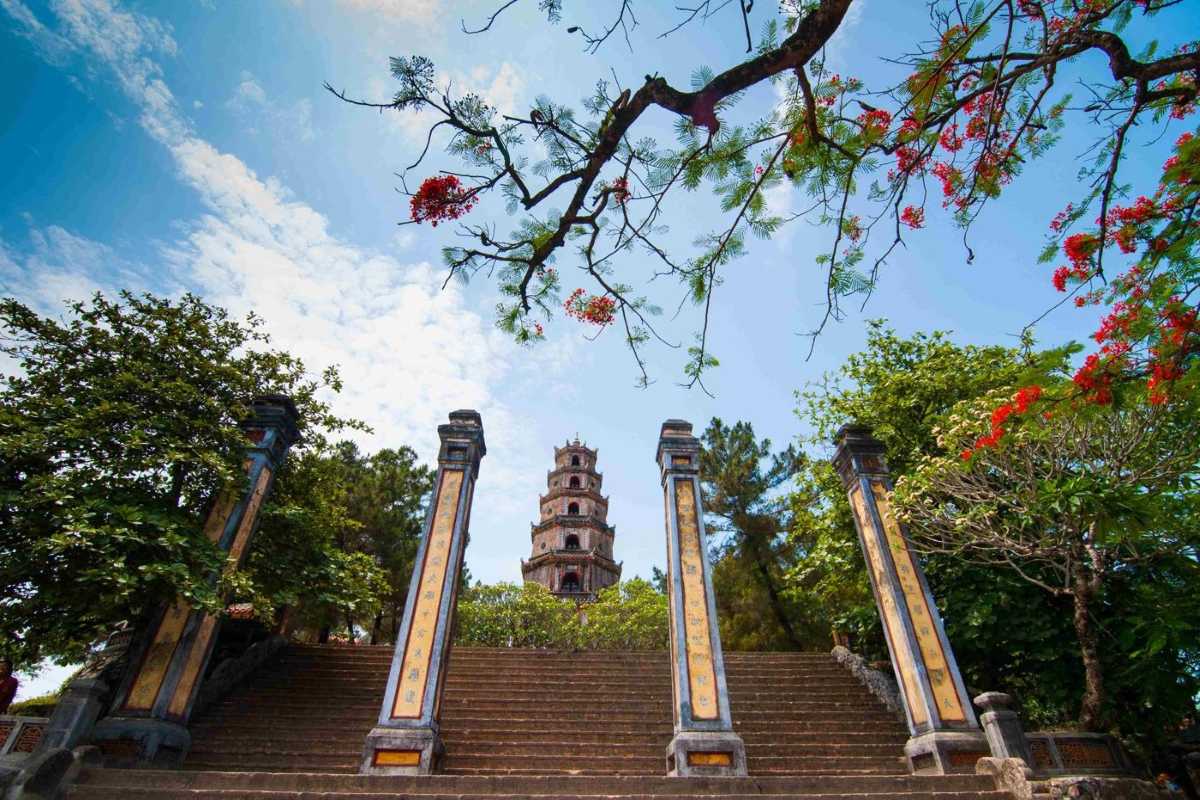 Ornate prayer hall at Thien Mu Pagoda with intricate Buddhist statues in Hue Ornate prayer hall at Thien Mu Pagoda features colorful Buddhist statues, detailed carvings, and offerings, reflecting Hue’s spiritual traditions.