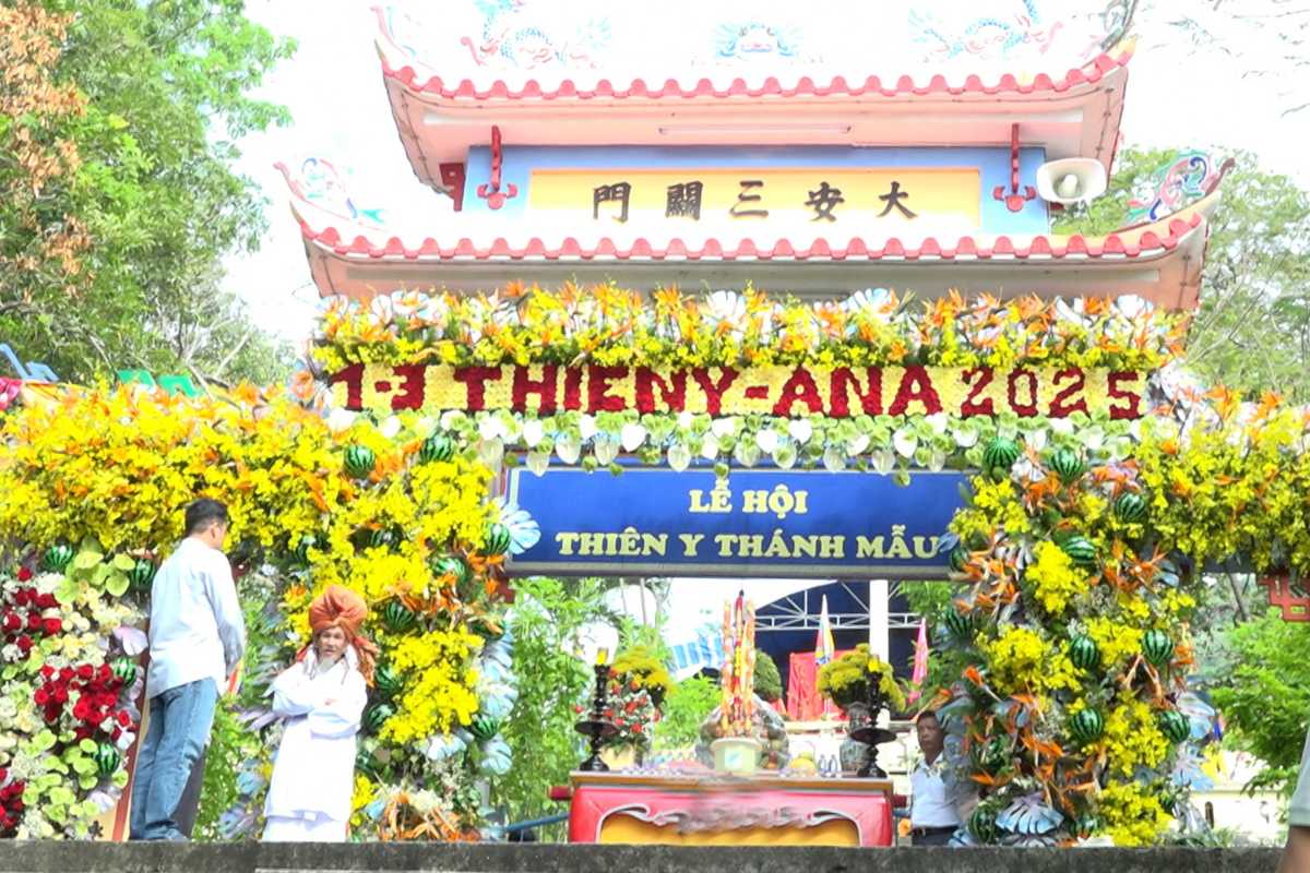 Thien Y A Na Festival gate floral decor Gate at Am Chua Temple decorated with yellow flowers and banners during Thien Y A Na Festival.