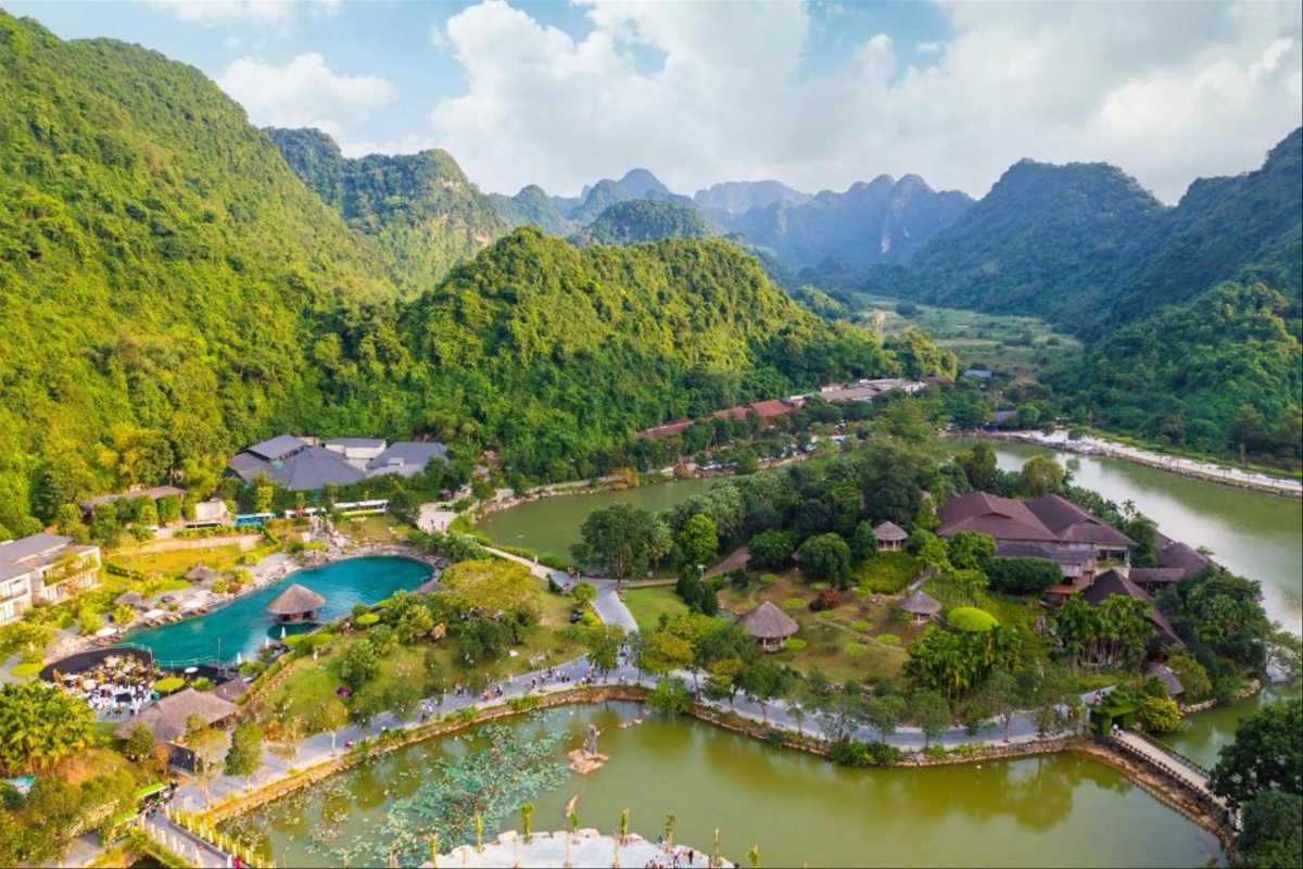Thung Nham Ninh Binh panoramic eco-tourism landscape Thung Nham Ninh Binh panoramic eco-tourism zone with hills, lakes, and visitor facilities under blue sky.