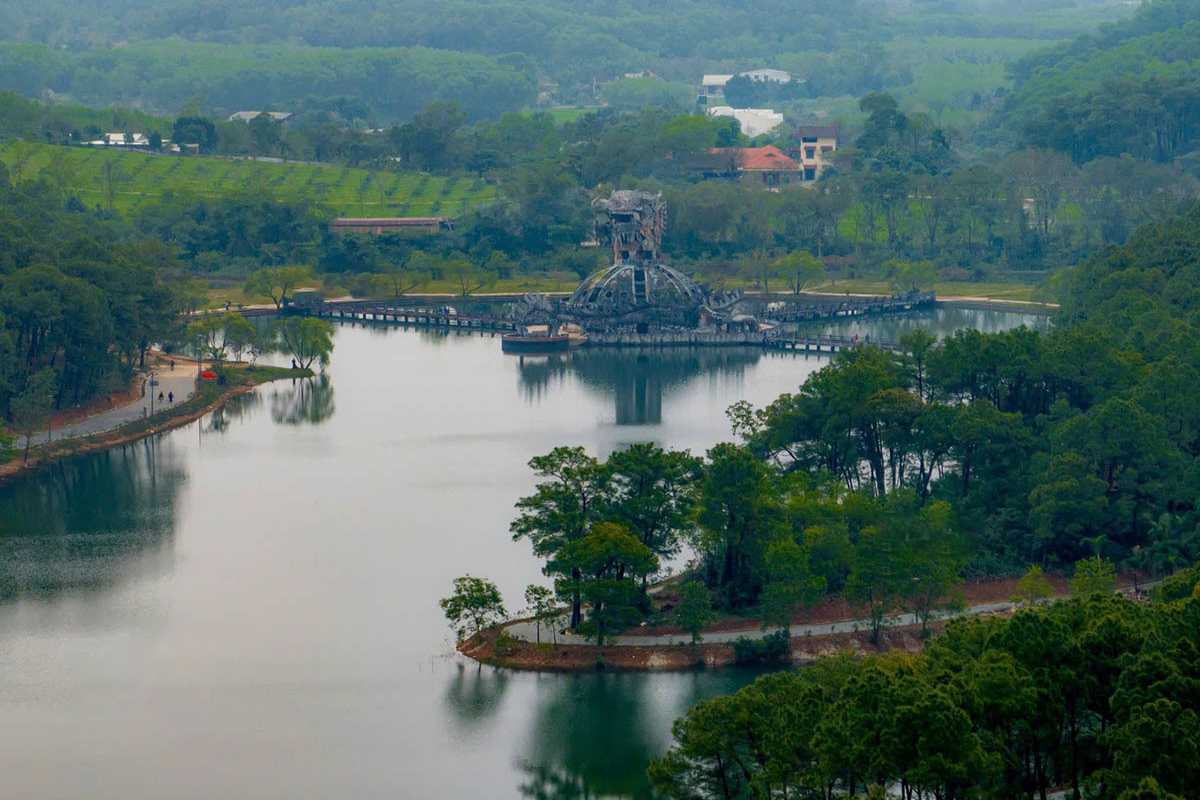 Distant View Dragon Dome Thuy Tien Lake Hue Dragon dome stands out in the distance, seen across Thuy Tien Lake with lush greenery and mountains behind