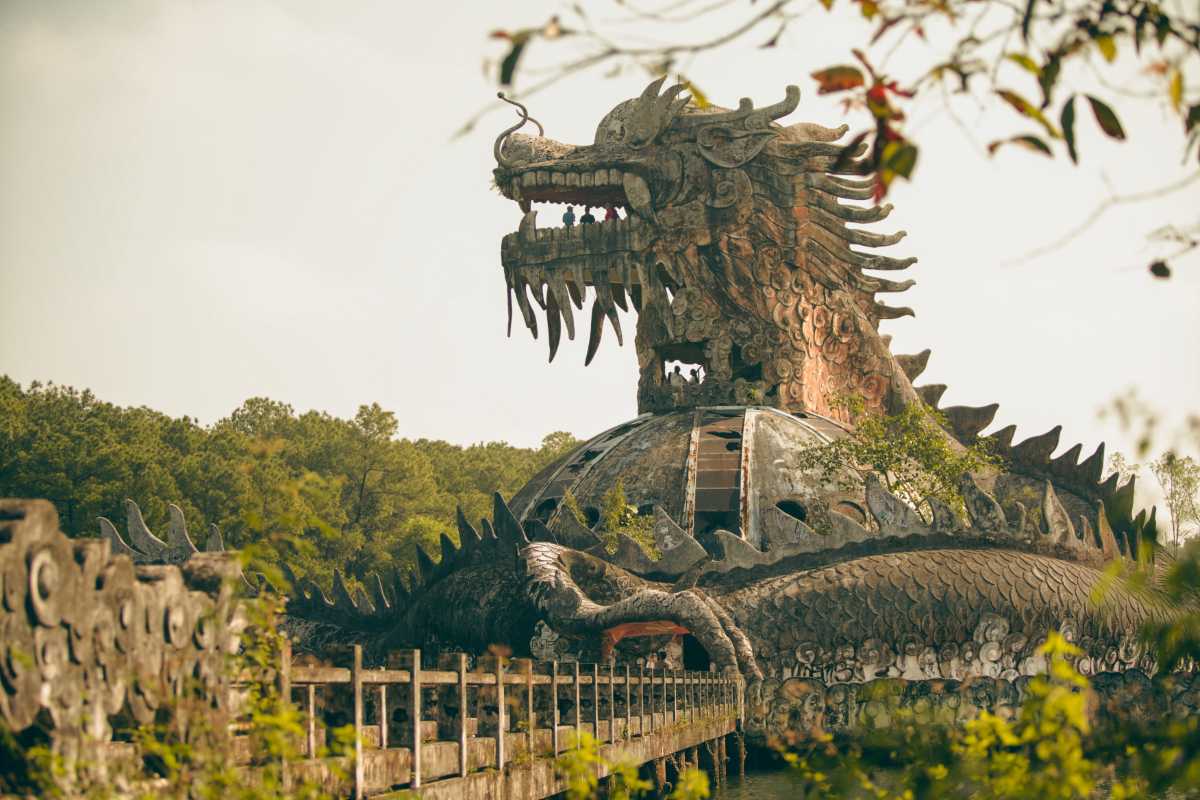 Close-Up Dragon Head Thuy Tien Lake Abandoned Water Park Intricate close-up of the dragon’s head atop Thuy Tien Lake’s iconic dome, with visitors standing inside the mouth
