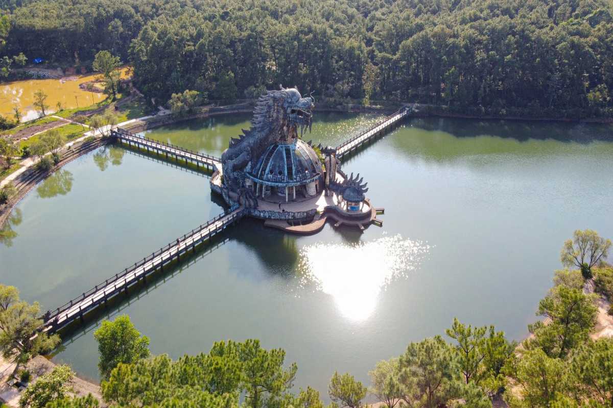 Dragon Structure on Thuy Tien Lake Hue Top-down aerial shot of the famous dragon structure surrounded by walkways over the tranquil water of Thuy Tien Lake