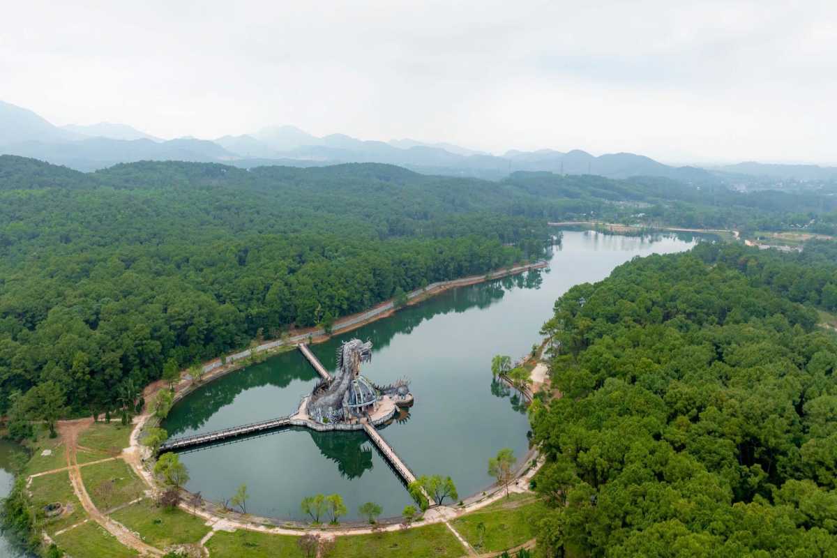 Aerial Panoramic of Thuy Tien Lake and Forested Hills Wide aerial panorama of Thuy Tien Lake, dragon dome, and rolling forested hills near Hue