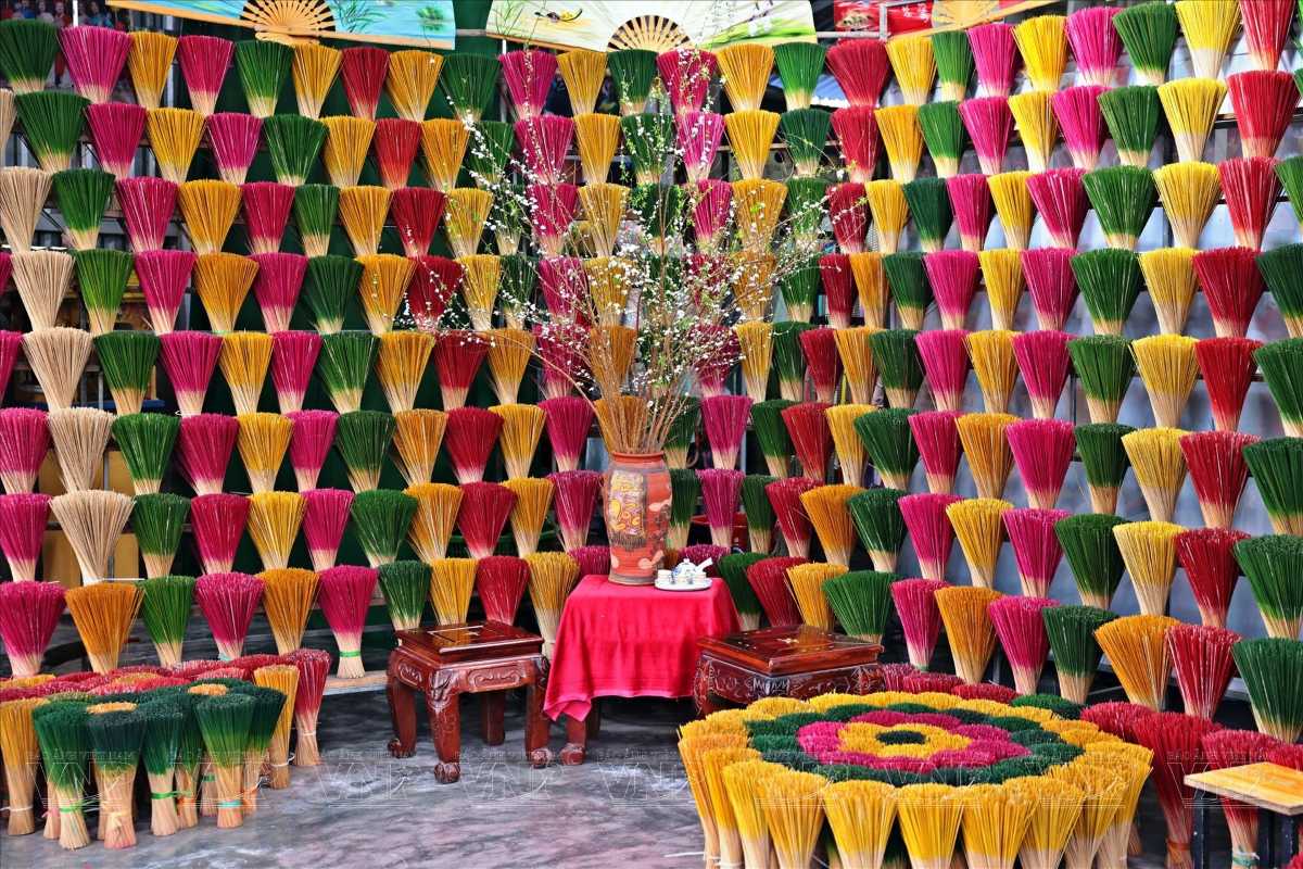 Incense Display Wall at Thuy Xuan Incense Village Hue Wall filled with hand-crafted, multicolored incense sticks arranged in patterns at Thuy Xuan Incense Village in Hue.