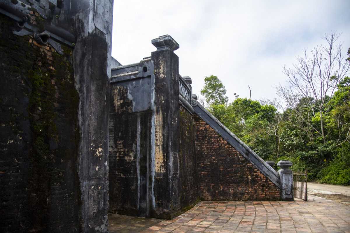 Tiger Arena Hue corner stairs with ancient brick and forest views Tiger Arena Hue corner staircase leads visitors up historic brickwork with scenic forested surroundings and lush green views beyond.