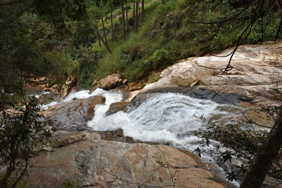 Tiger Waterfall Da Lat Wide Waterfall View with Mist Wide view of mist-covered Tiger Waterfall Da Lat cascading over moss-covered rocks in a forest setting