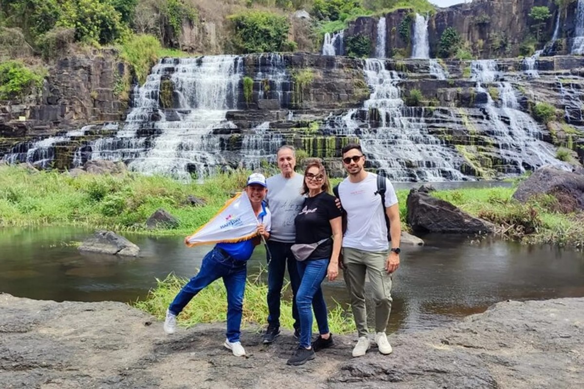 Tourists at Pongour Falls with scenic waterfall view