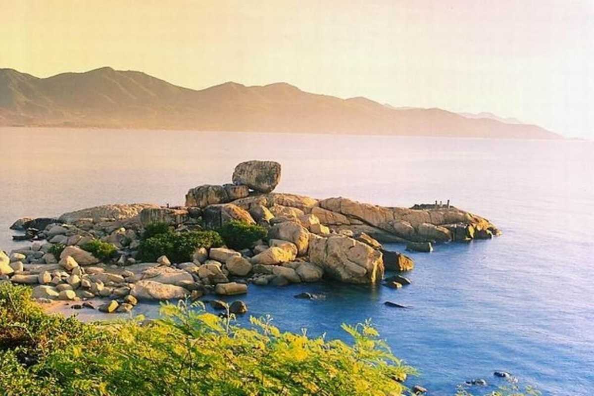 Tourists Exploring Granite Rocks at Da Chong Wharf Visitors climbing granite rock formations at Da Chong Wharf, Nha Trang