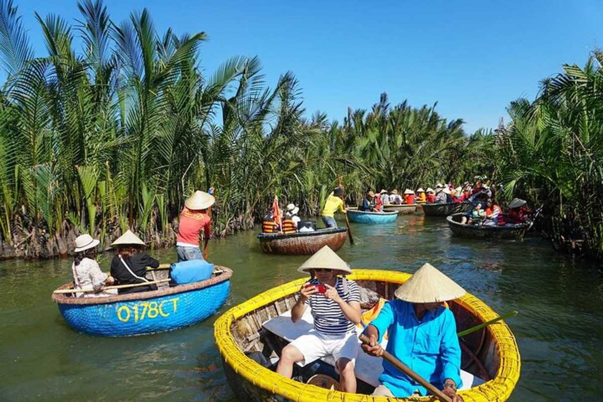 Traditional Basket Boat Ride in Cam Thanh Coconut Village Visitors rowing traditional basket boats through lush coconut groves in Cam Thanh Coconut Village