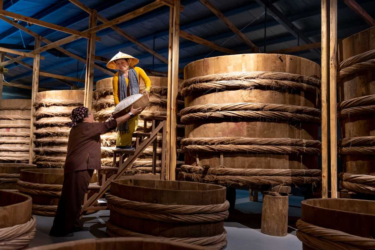 Large wooden fermentation barrels used in Traditional Phu Quoc Fish Sauce production process
