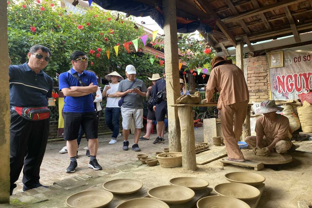 Traditional Pottery Making at Thanh Ha Pottery Village Artisan shaping clay pottery on a spinning wheel at Thanh Ha Pottery Village in Hoi An
