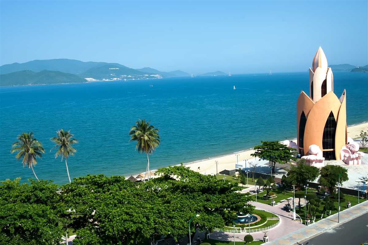 Tram Huong Tower by the sea Tram Huong Tower seen from above with turquoise sea and palm trees in view