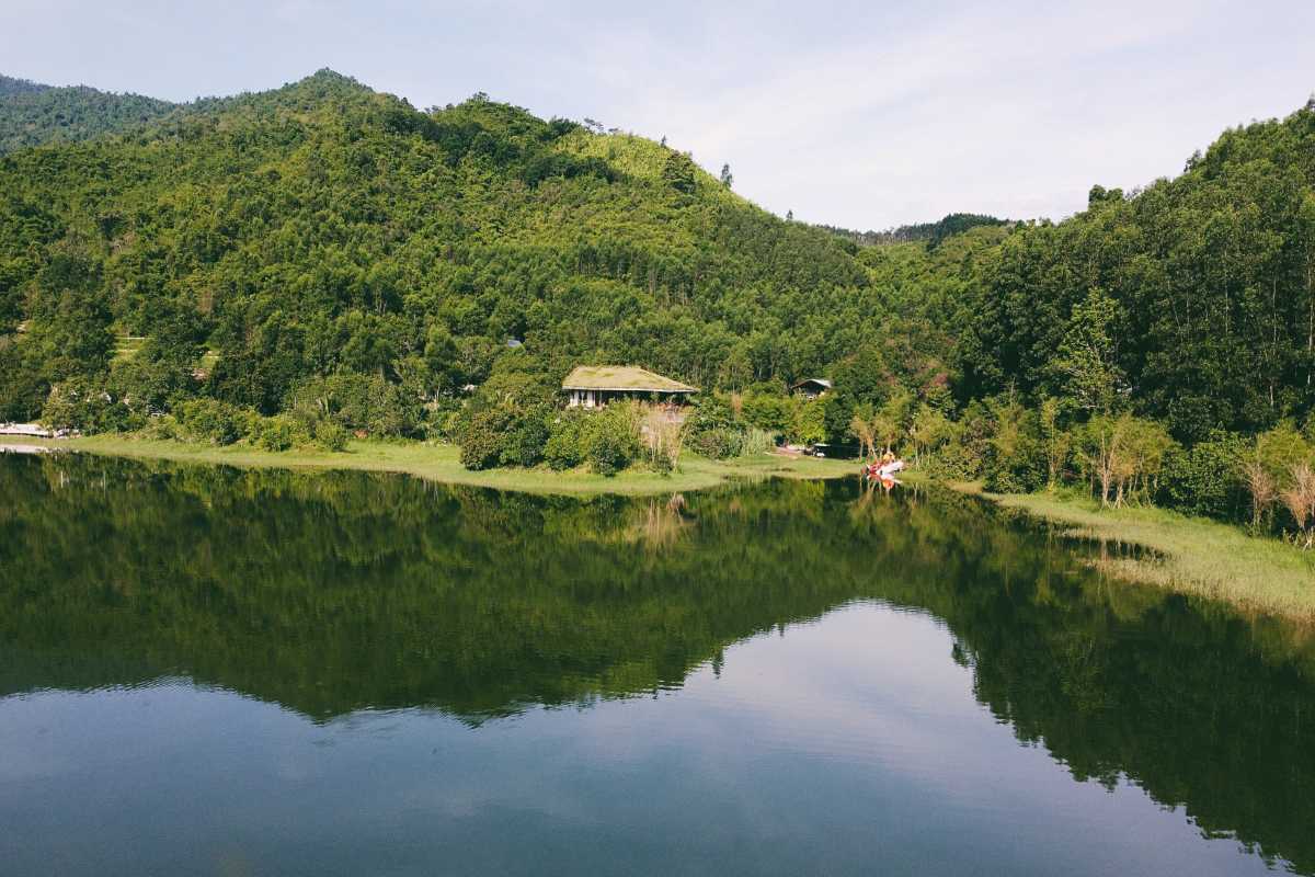 Tranquil Lake in Hon Ba Nature Reserve Calm reflective lake surrounded by green hills at Hon Ba Nature Reserve