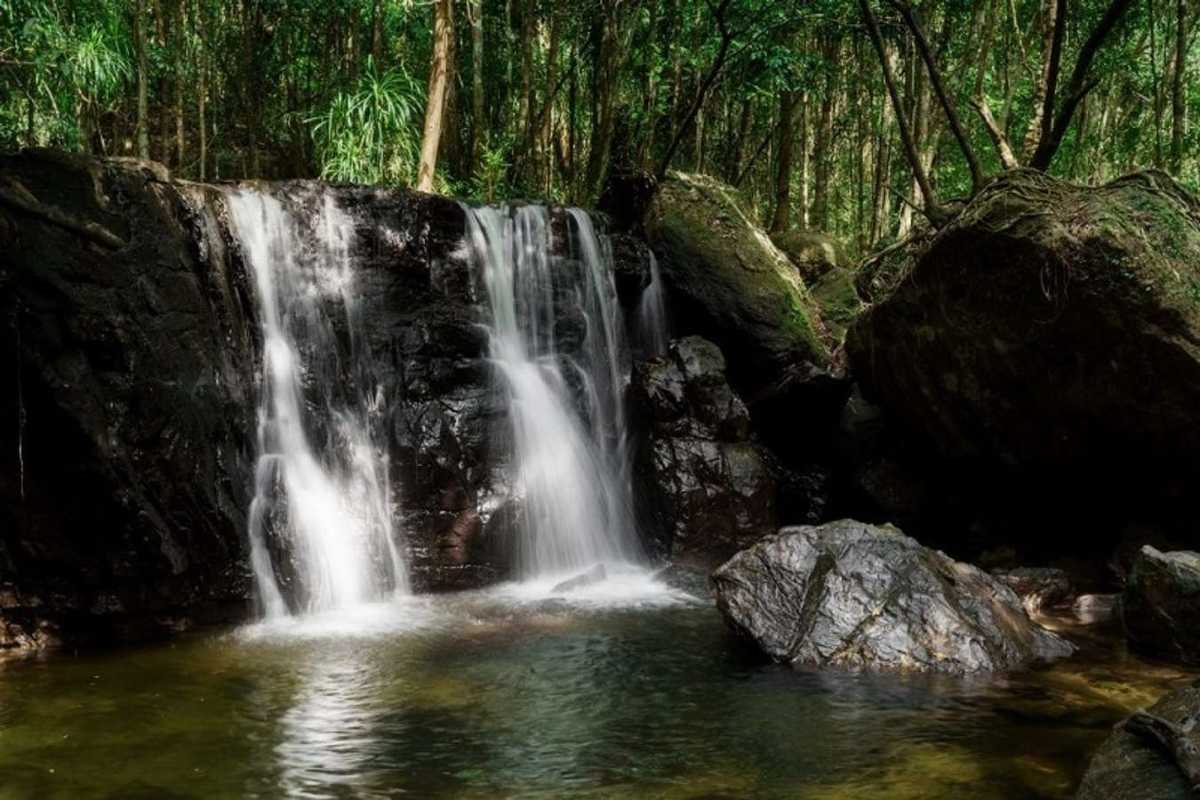 Tranquil Waterfall Basin at Tranh Stream Phu Quoc Wide waterfall basin with calm water at Tranh Stream in Phu Quoc rainforest