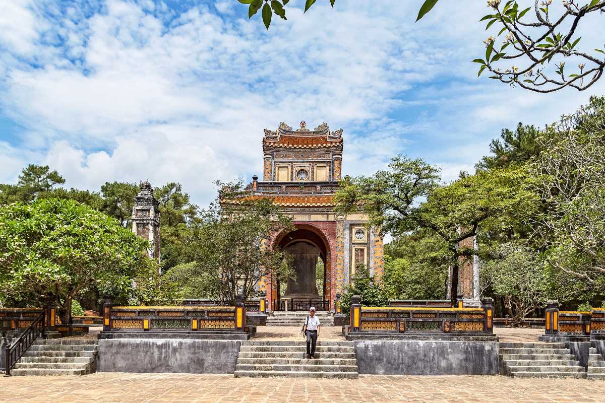 Ornate Archway and Stele Pavilion at Tu Duc Tomb Colourful archway with stele pavilion at Tu Duc Tomb, surrounded by lush trees