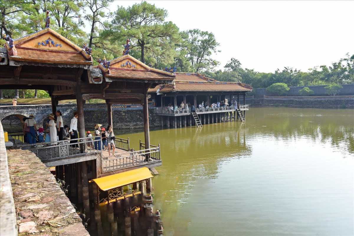 Tu Duc Tomb Pavilion Overlooking Tranquil Lake Pavilion at Tu Duc Tomb overlooking the calm lake surrounded by ancient trees and architecture