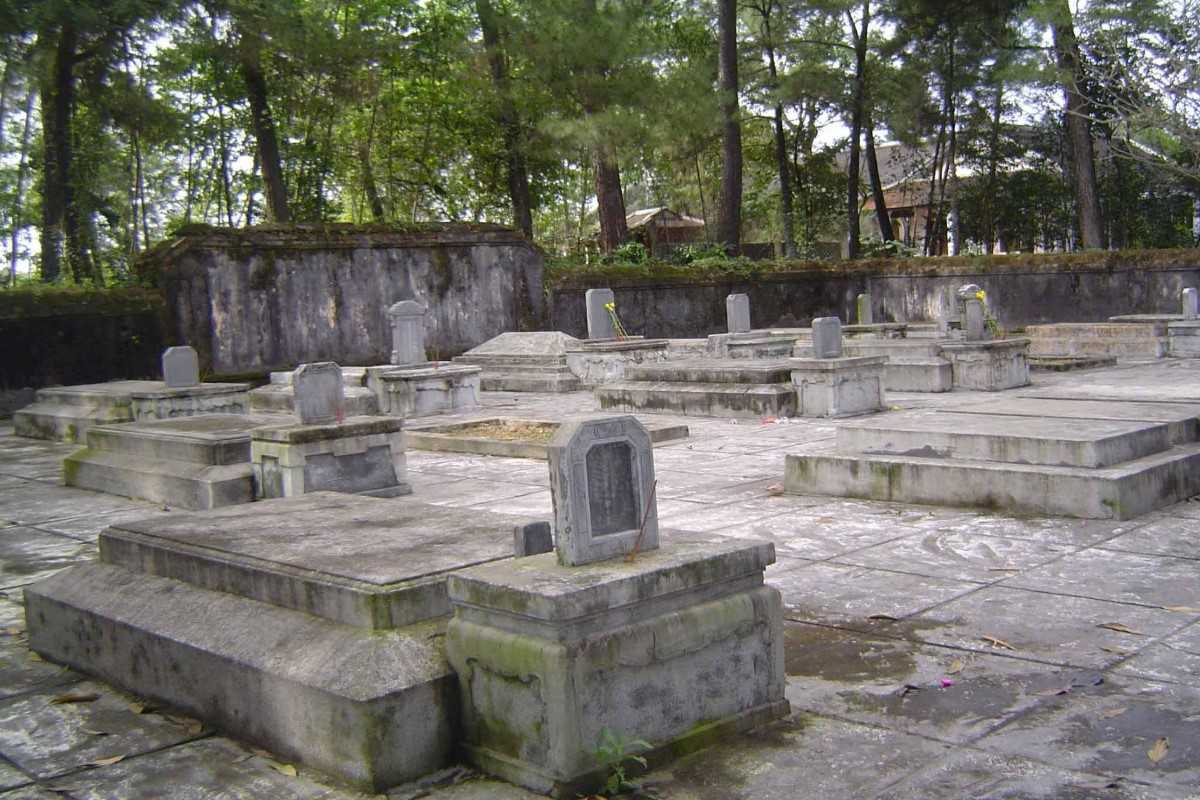 Eunuch Cemetery at Tu Hieu Pagoda Ancient stone graves at Tu Hieu Pagoda surrounded by pine trees, honoring royal eunuchs of the Nguyen Dynasty.