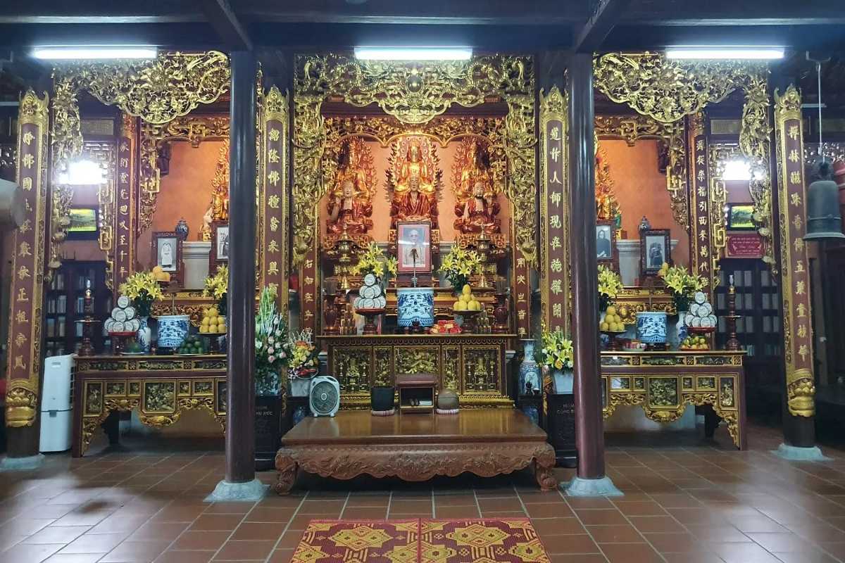 Tu Van Pagoda Nha Trang Ornate Golden Buddhist Shrine Interior Interior view of Tu Van Pagoda showing ornate golden Buddhist altar with statues and offerings